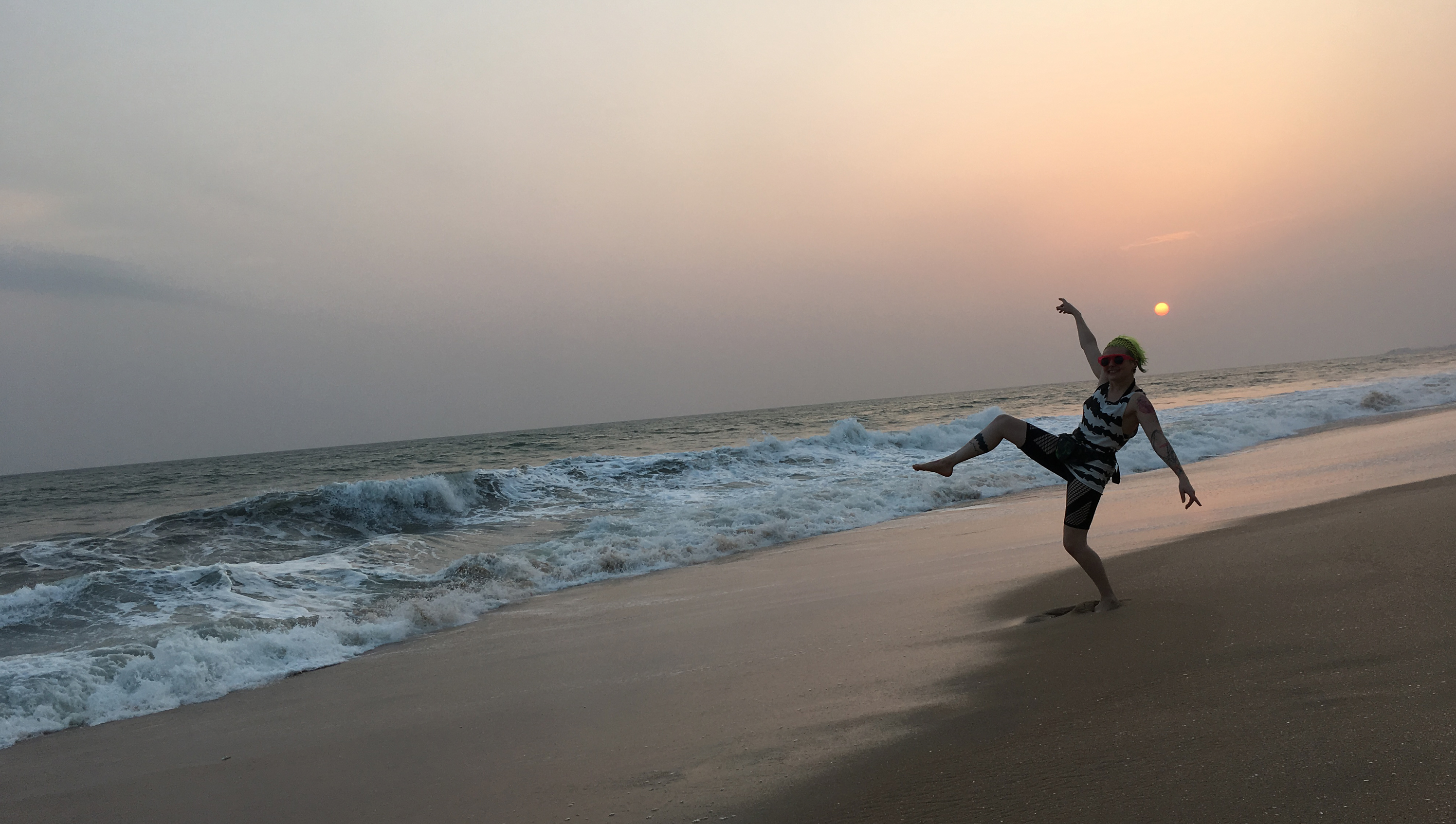 Anna Skodbo on a beach in Ghana under the setting sun